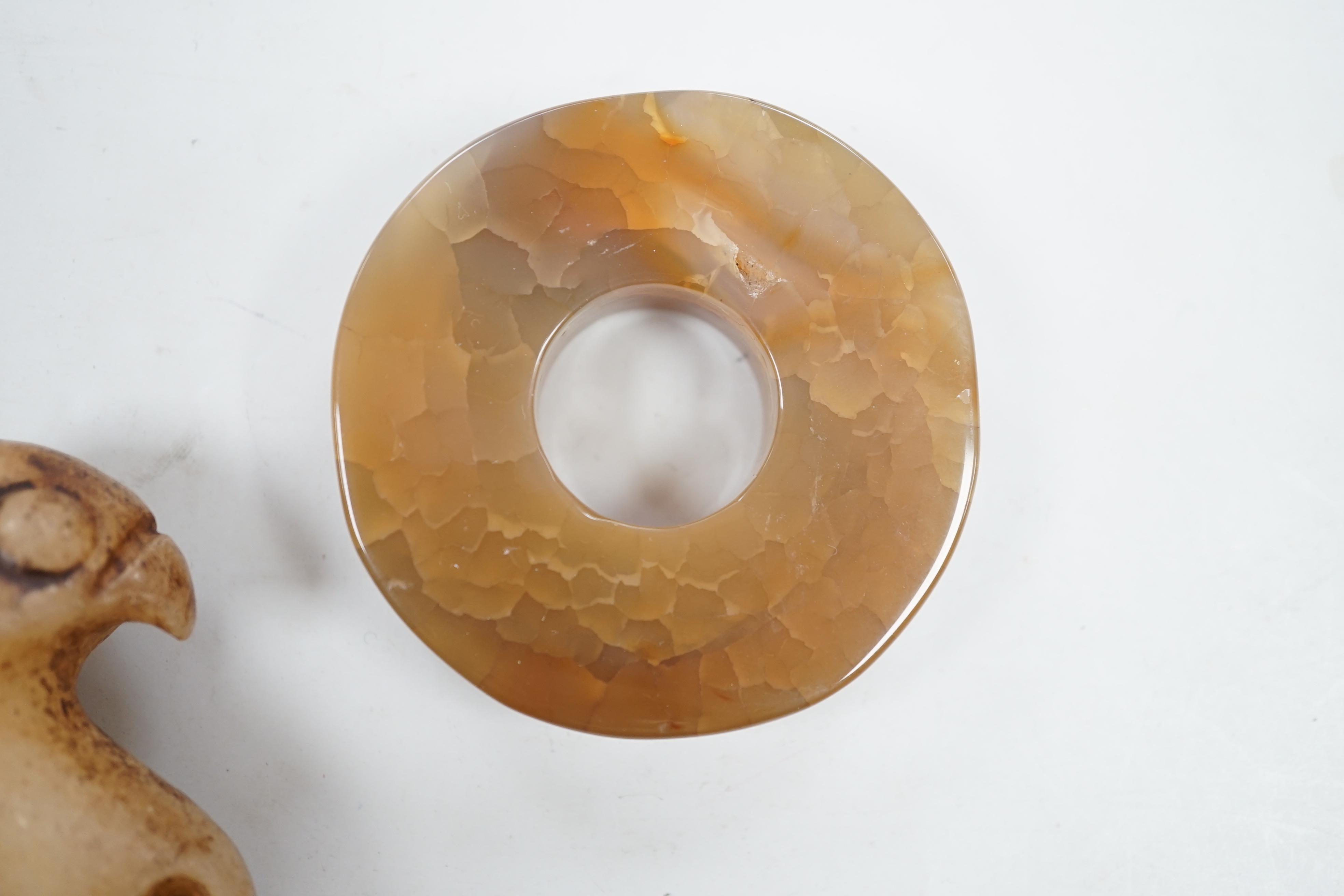 A Chinese agate bi disc and an archaistic jade eagle, 8.5cm